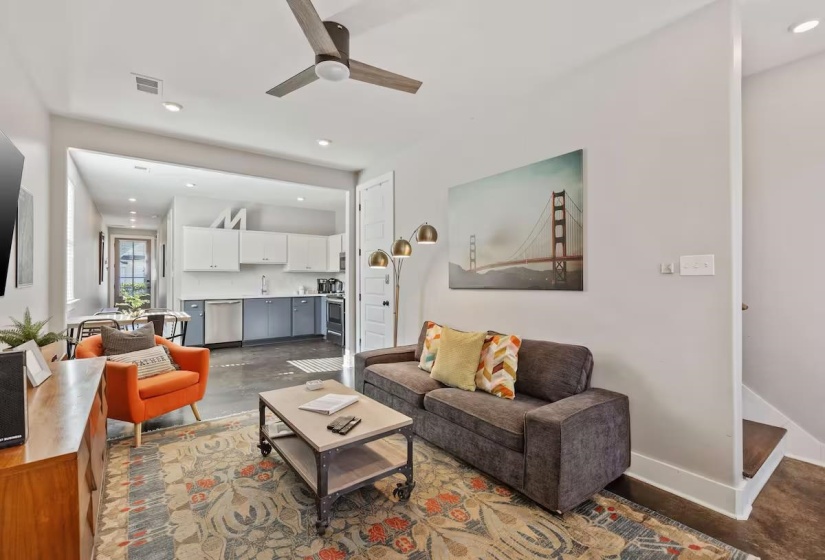 Open-concept living space featuring a ceiling fan, recessed lighting, and wood-finish flooring