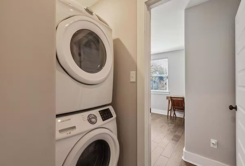 Dedicated laundry area featuring a stacked washer and dryer
