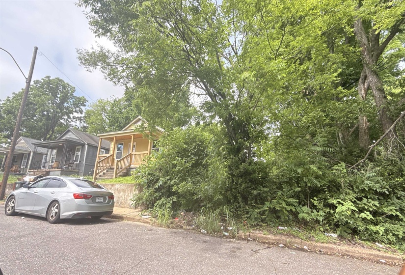 Wood-sided property featuring a covered front porch with wood railings and steps