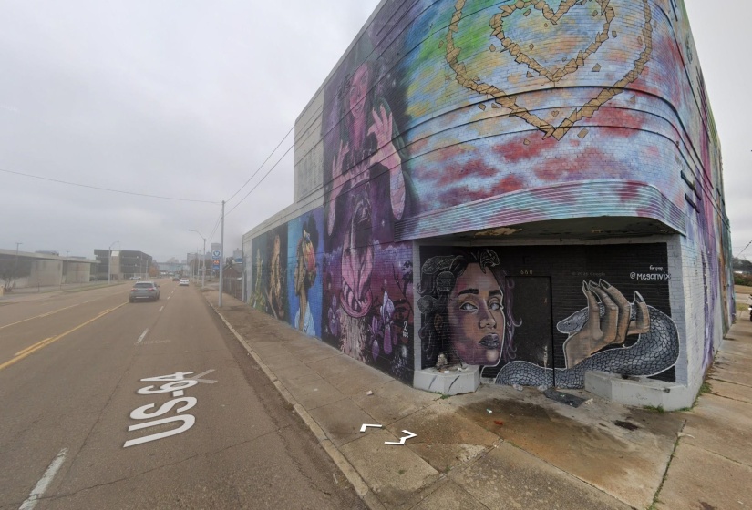 Building exterior featuring extensive colorful mural artwork