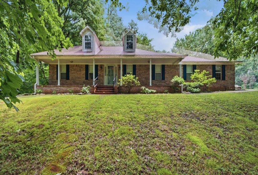 Brick exterior home with a broad covered front porch