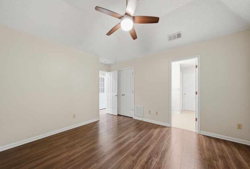 Bedroom featuring a textured carpet, white walls, and a coffered ceilings & ceiling fan with wood-finish blades