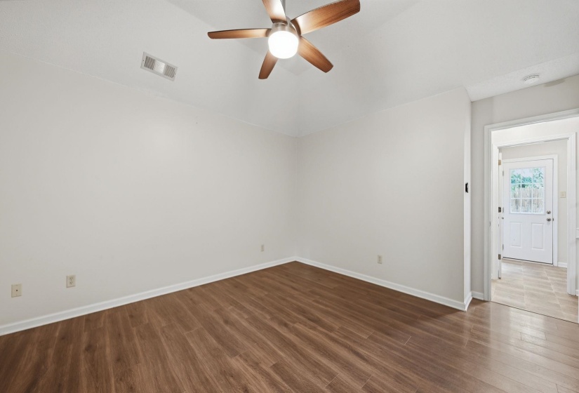 Bedroom featuring a textured carpet, white walls, and a coffered ceilings & ceiling fan with wood-finish blades