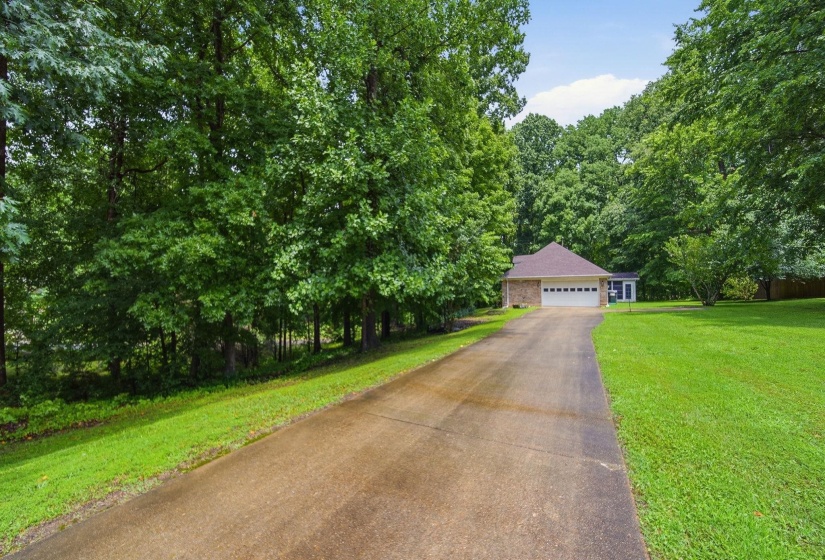 Spacious driveway approaching a single-story residence with a two-car garage