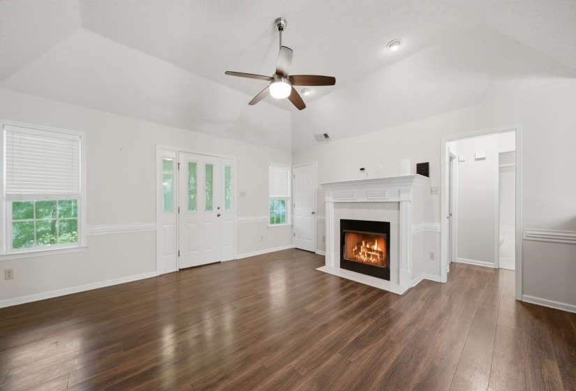 Great Room hosts plank floors,vaulted ceiling, ceiling fan ,fireplace with ventless gas logs.