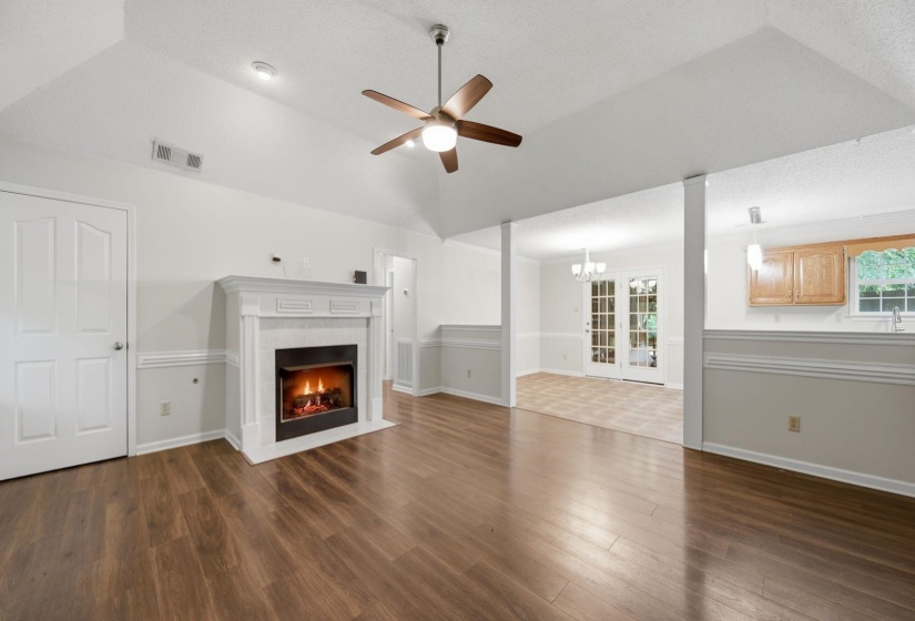 Great Room hosts plank floors,vaulted ceiling,fireplace with ventless gas logs.