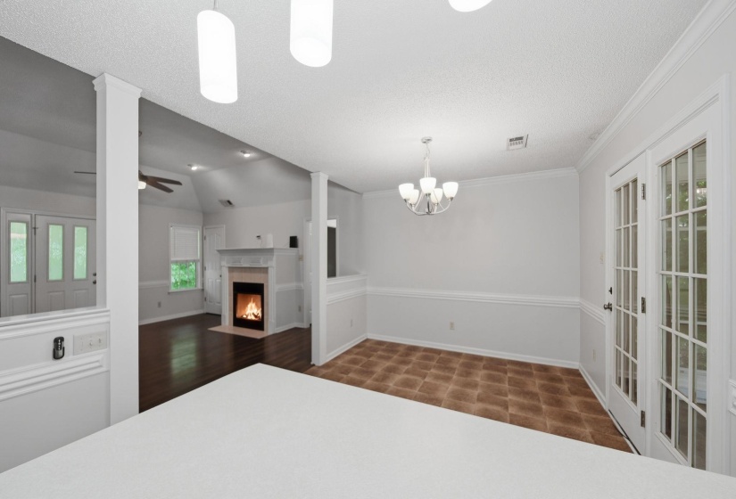 Dining area featuring vinyl flooring, a chandelier, and French doors