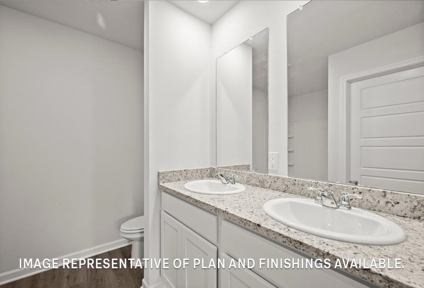 Vanity featuring dual undermount sinks, granite countertop, and white cabinetry