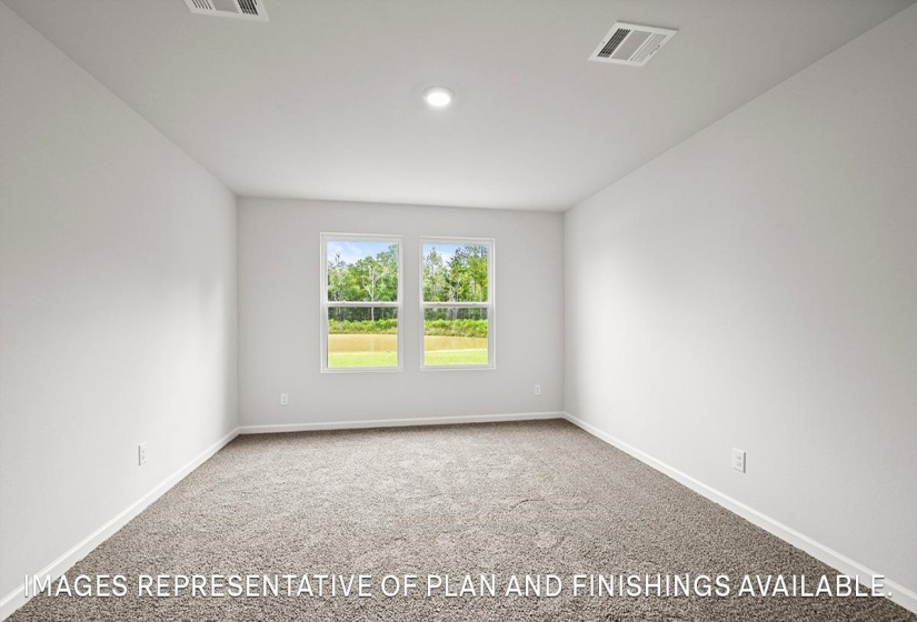 Bright interior room featuring a neutral color palette, two windows, recessed lighting, and soft gray carpeting