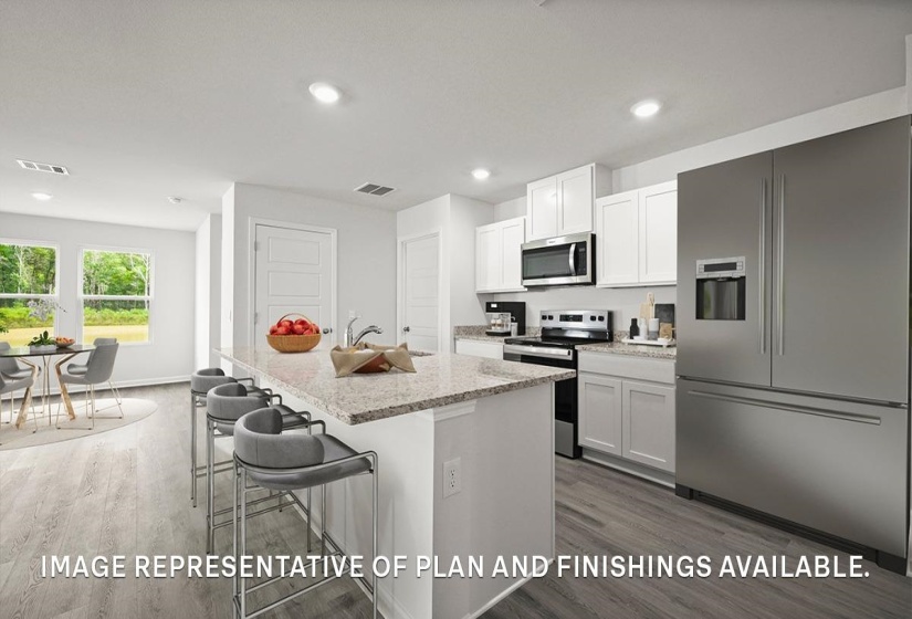 Kitchen featuring a large island with stone countertop, stainless steel appliances, white cabinetry, and wood-finish flooring