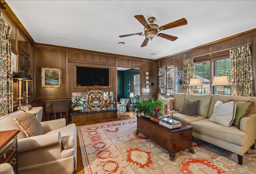 Paneled walls with integrated cabinetry and a built-in media area