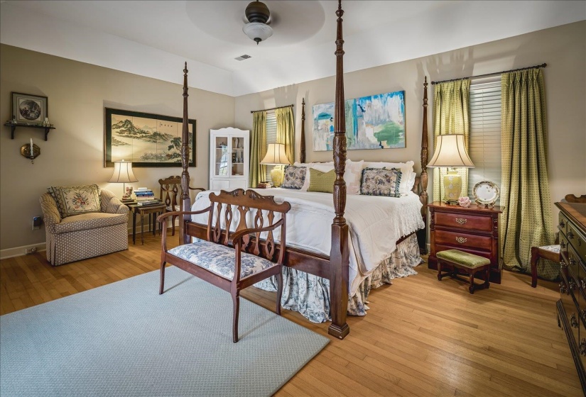 Spacious room featuring light wood-finish flooring, a tray ceiling, and neutral wall tones