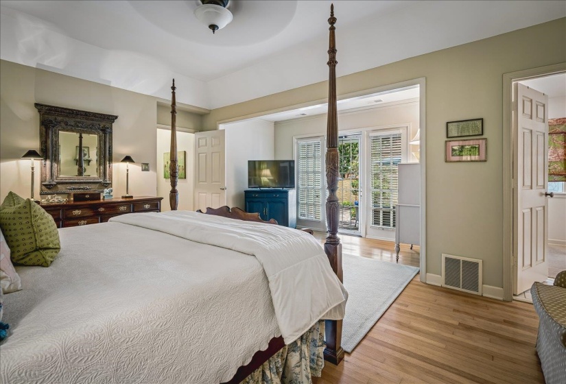 Hardwood flooring throughout, recessed ceiling, and French doors leading to an outdoor area