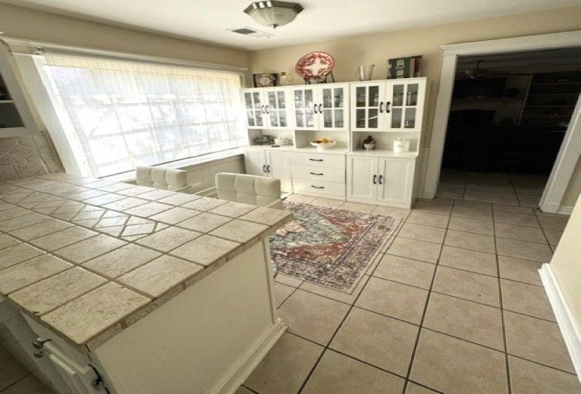 Kitchen area featuring a tile countertop island