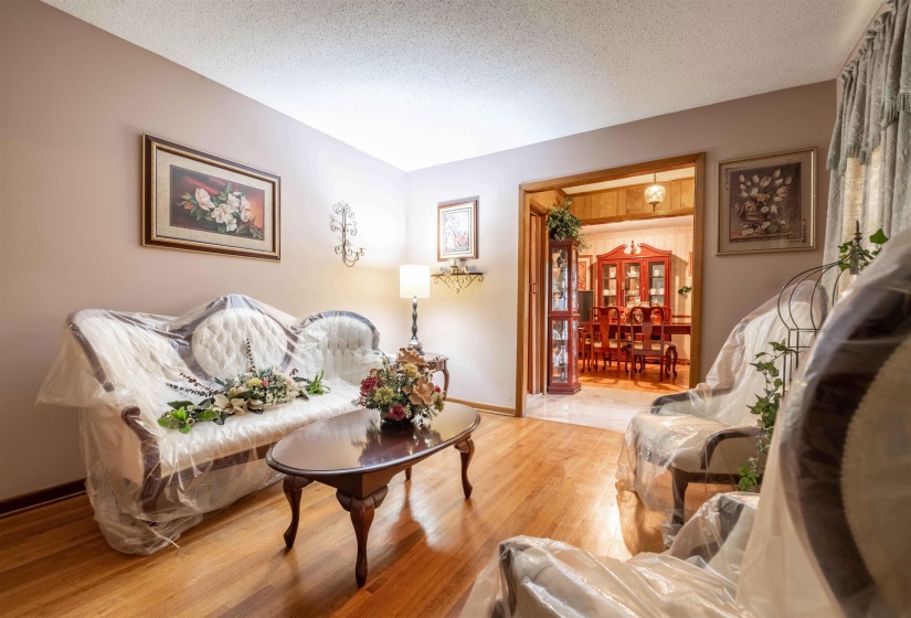 Hardwood-finish flooring runs through the living area, featuring light-toned walls