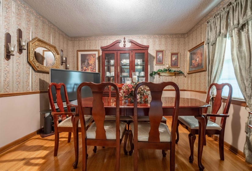 Formal dining area with wood-finish flooring
