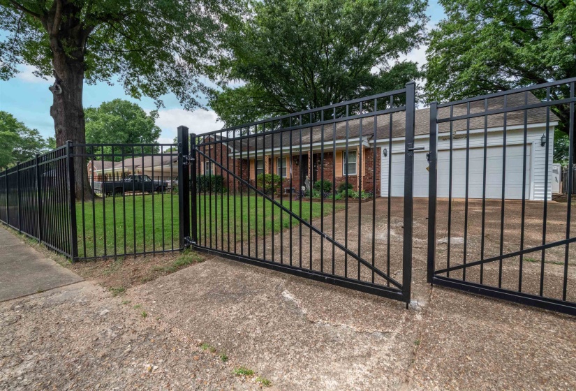 Black wrought iron fencing with matching double gates