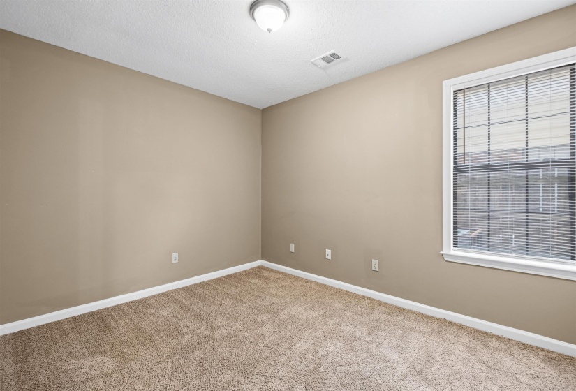 Room featuring neutral wall paint, white trim, and light brown carpet