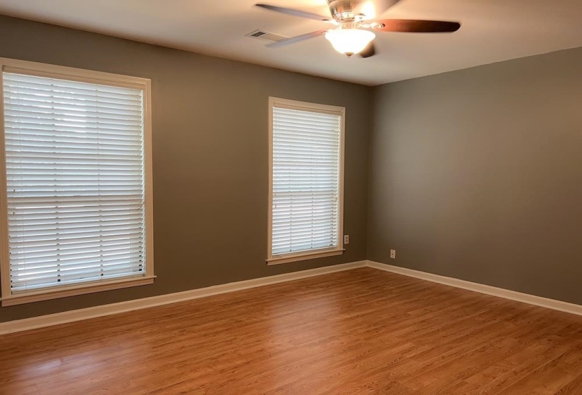 Neutral painted walls and wood-finish flooring define this interior space