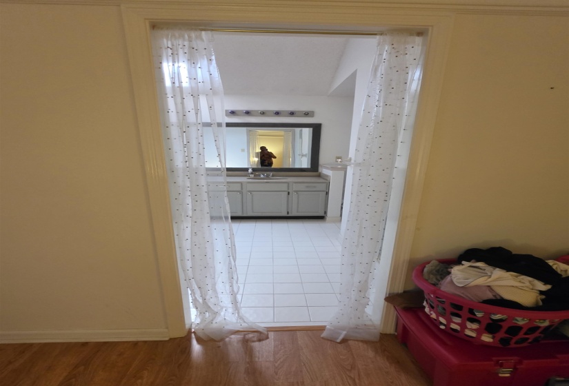 Bathroom featuring a single vanity with a countertop, square basin, and framed mirror