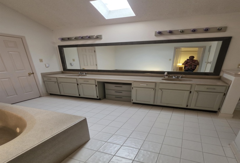 Double vanity with integrated sinks, light-toned countertops, and under-counter cabinetry