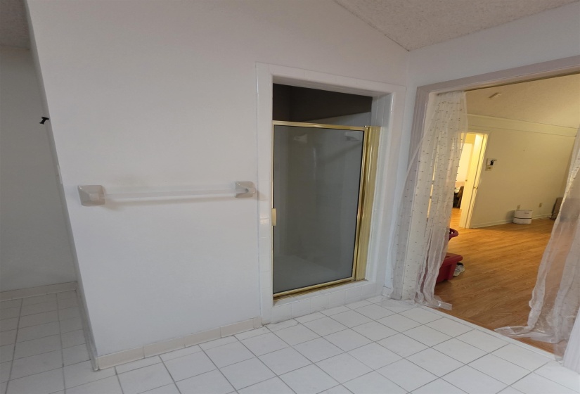 Shower stall with gold-tone framed glass door