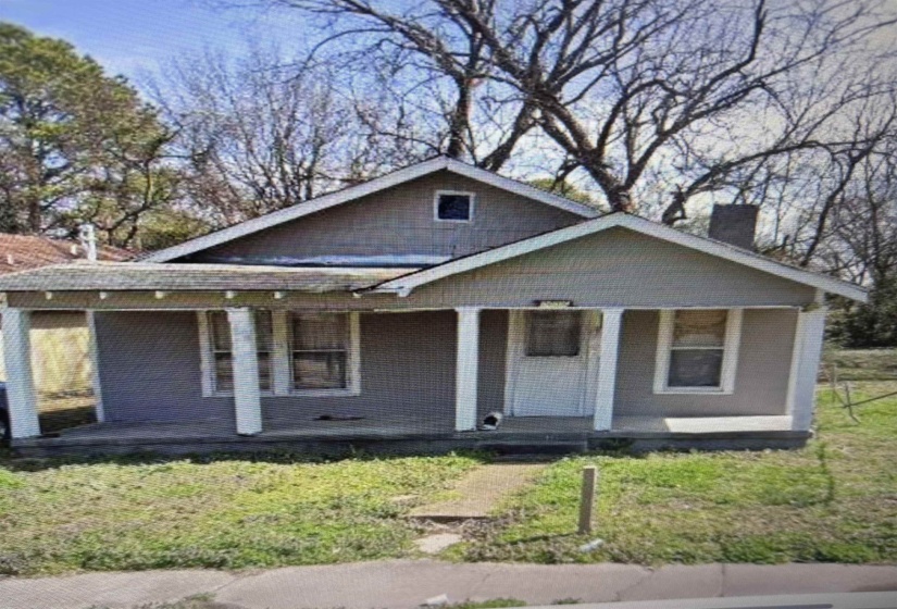 Gray-hued residence with a front porch, supported by white columns, and an exposed aggregate walkway
