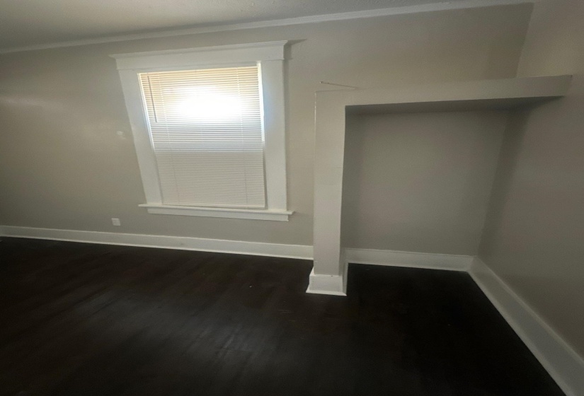 Dark wood-finish flooring with crisp white baseboards