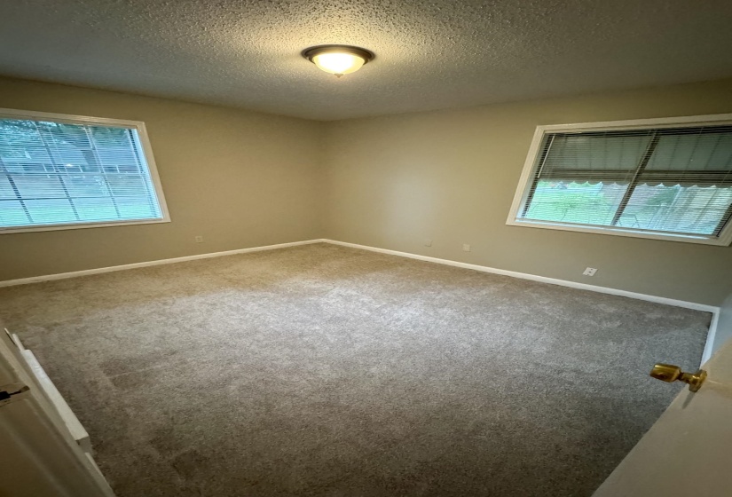 Neutral-toned walls complement the textured carpeting