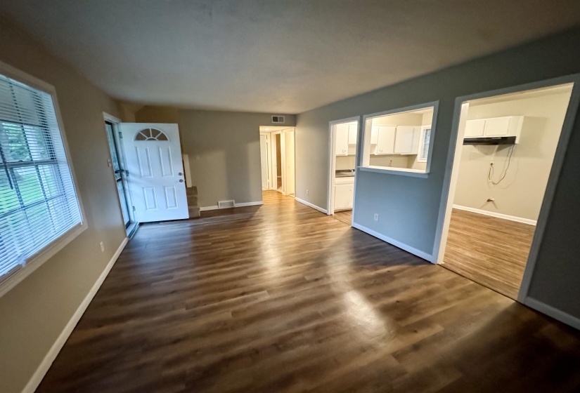 Spacious interior featuring wood-finish flooring, neutral paint palette, and white trim throughout