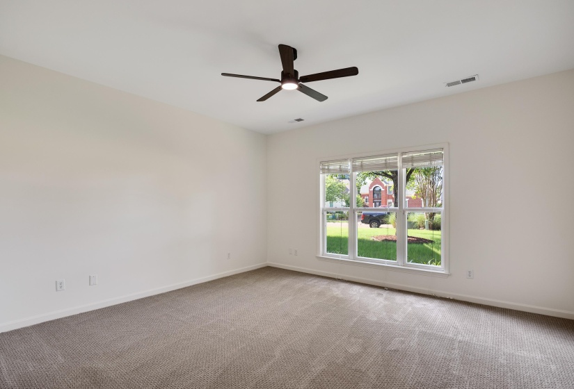 Neutral wall tones complement the neutral carpet flooring