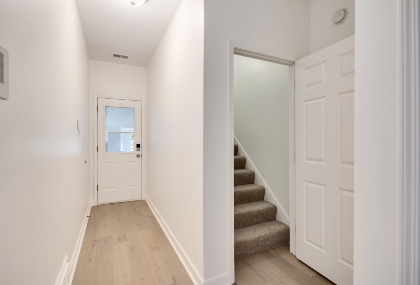 Foyer featuring light wood-finish flooring and white baseboards