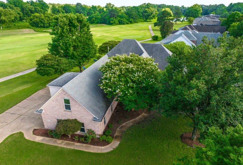 Brick residence featuring a gabled roofline and attached garage