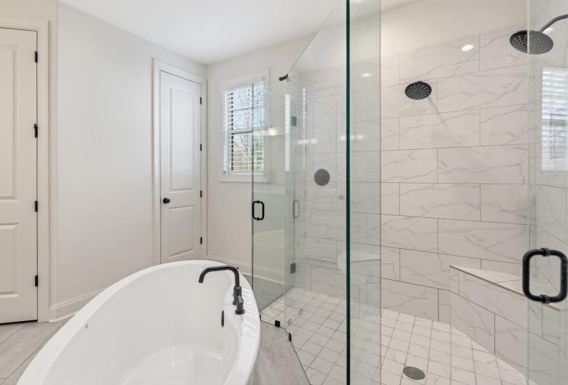 Full bath with a stall shower and a soaking tub