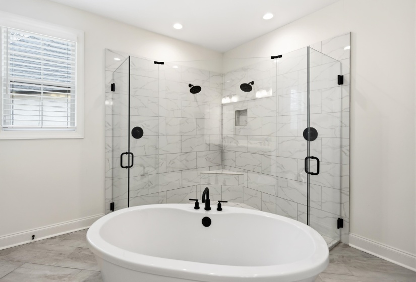 Full bathroom with a freestanding tub and a shower stall