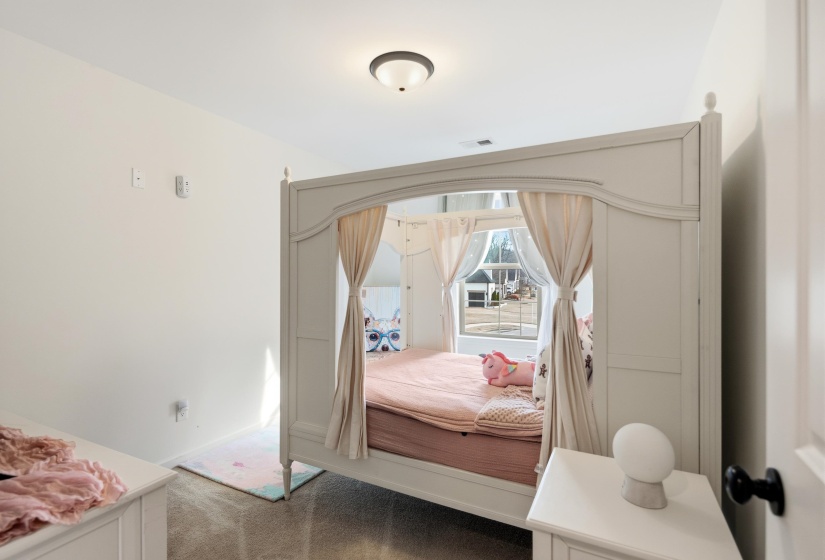 Bedroom featuring light colored carpet