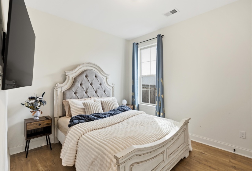 Bedroom featuring baseboards and wood finished floors