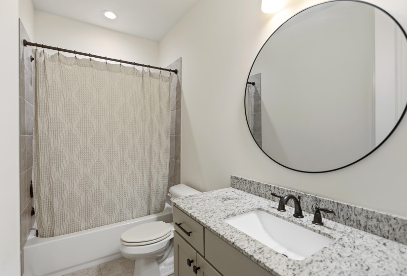 Full bath featuring vanity and shower / bathtub combination with curtain