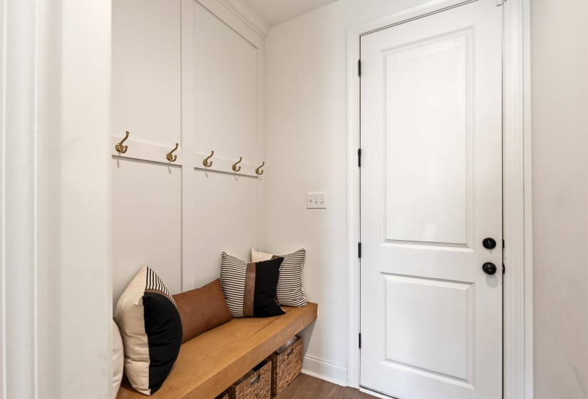 Mudroom with dark wood-type flooring and baseboards