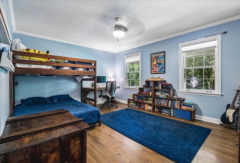 Spacious room featuring wood-finish flooring and light blue walls