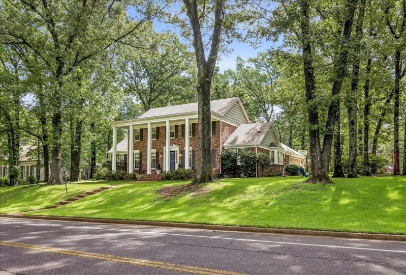Brick exterior with white columned portico