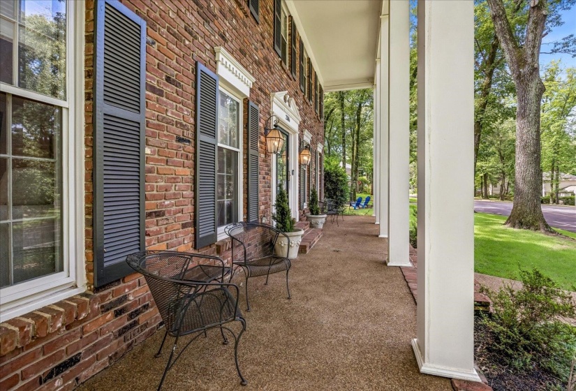 Brick exterior with white window trim and black louvered shutters