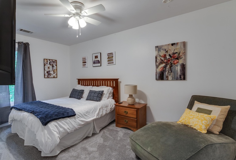 Bright room featuring white walls and grey carpet flooring