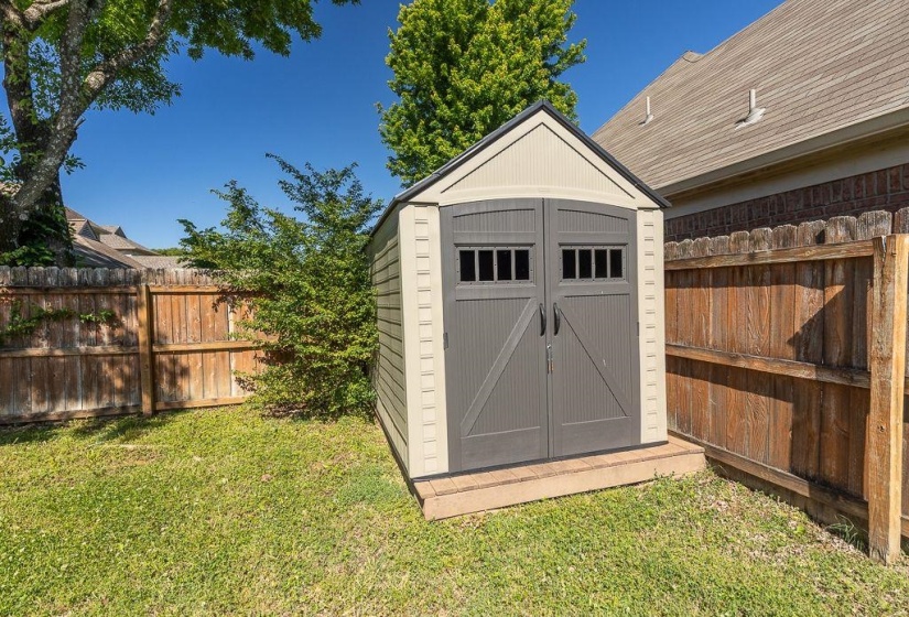 Outdoor storage shed featuring double doors with window details