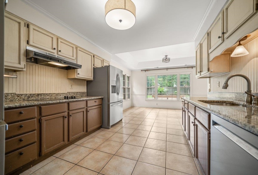 Spacious kitchen featuring granite countertops and tile flooring