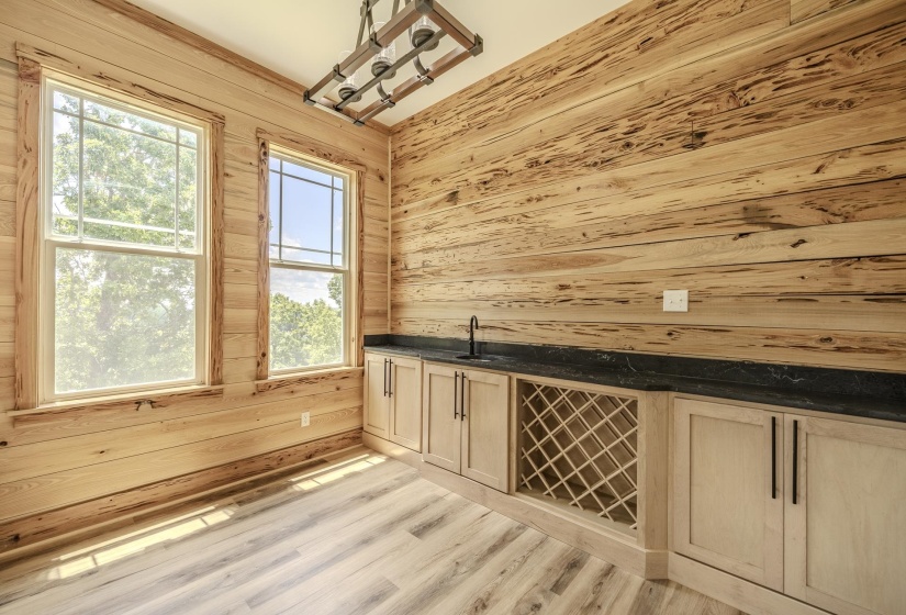 Light wood-finish flooring complements the natural wood-paneled walls