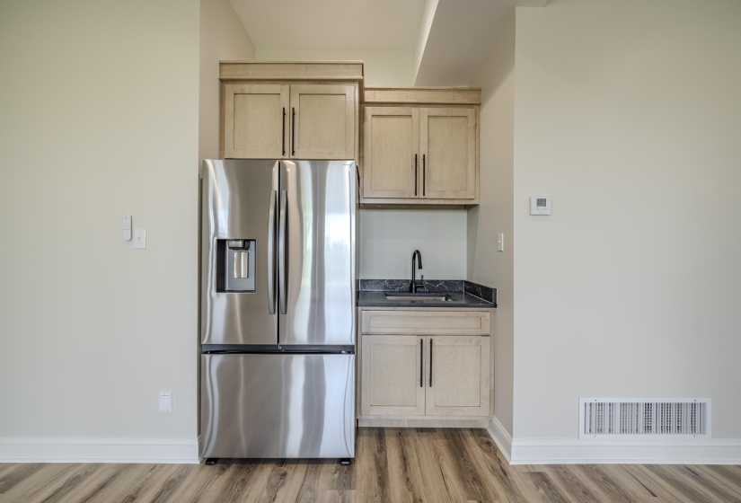 Stainless steel French door refrigerator with an integrated ice and water dispenser