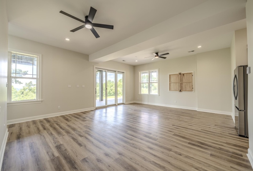 Spacious interior featuring wood-finish flooring, light-toned walls, and recessed lighting