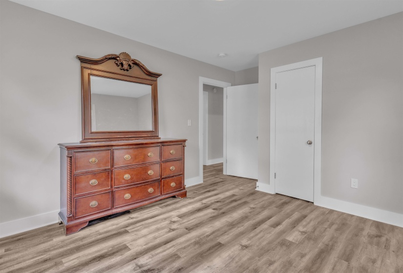 Wood-finish flooring throughout, complemented by light gray wall paint and crisp white trim