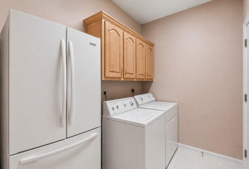LAUNDRY ROOM (08x06) – Convenient laundry room with six storage cabinets and a second pantry, providing exceptional organization and convenience. Virtually staged photo.